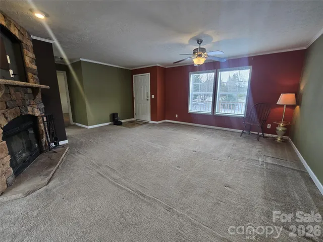a view of a livingroom with furniture and a window