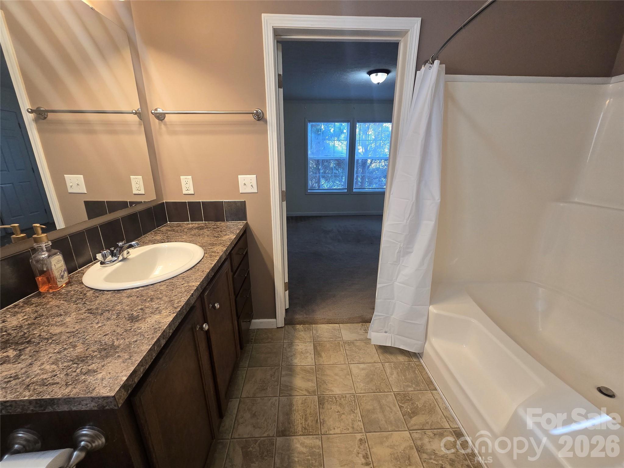 703 Garren Creek Road Fairview, NC 28730 - Photo 33 of 48 a bathroom with a granite countertop sink and a mirror