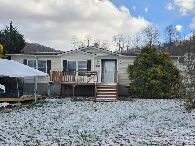 a house that has a lot of plants and trees in the background