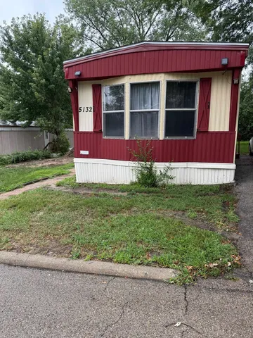a view of front of house with a yard