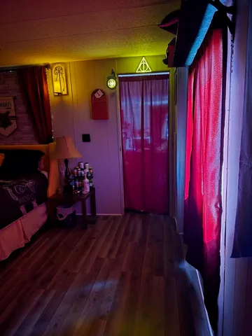 a view of a room with wooden floor and windows