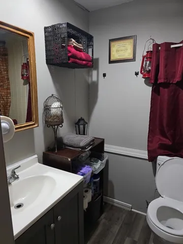 a bathroom with a toilet sink and mirror