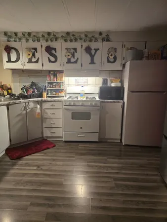 a kitchen with stainless steel appliances a stove a refrigerator and a sink