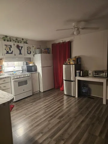 a kitchen with stainless steel appliances a stove a refrigerator and a sink