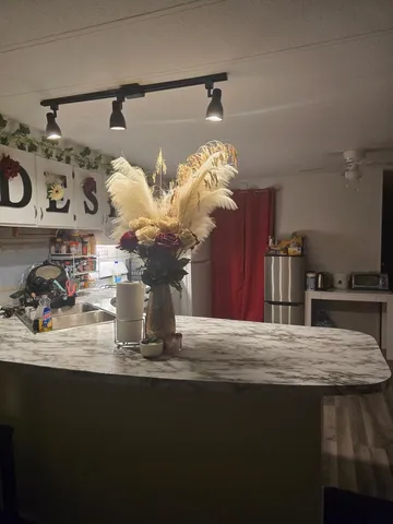 a view of a dining room with kitchen countertops and chandelier