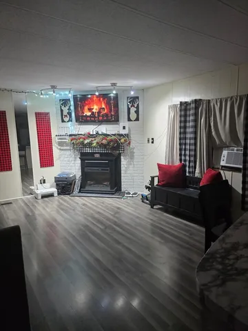 a living room with furniture a flat screen tv and a fireplace