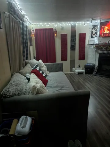 a bedroom with a bed tv and a fireplace