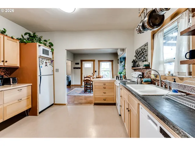 a kitchen with white cabinets and appliances