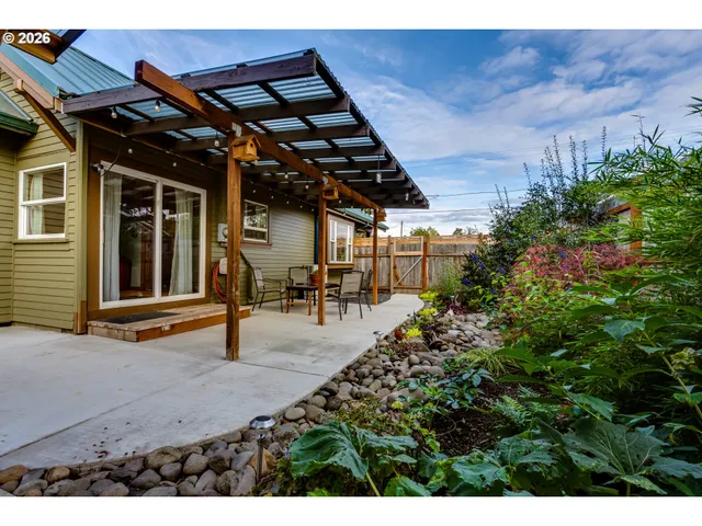a view of a backyard with plants and a patio