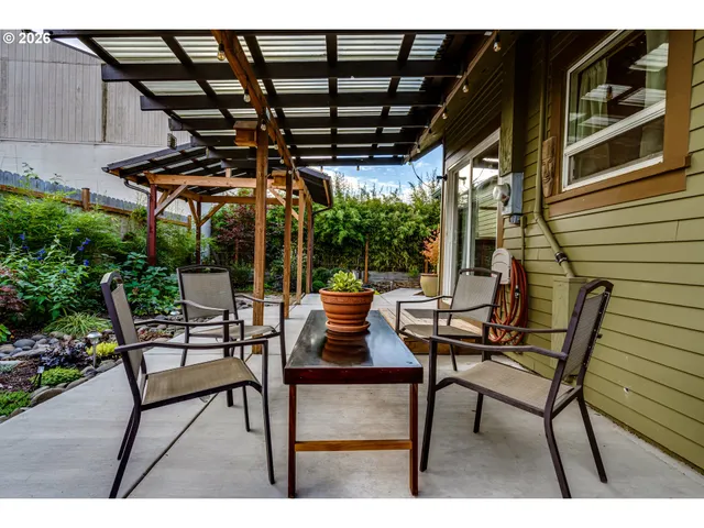 a outdoor view with a sitting space and large trees