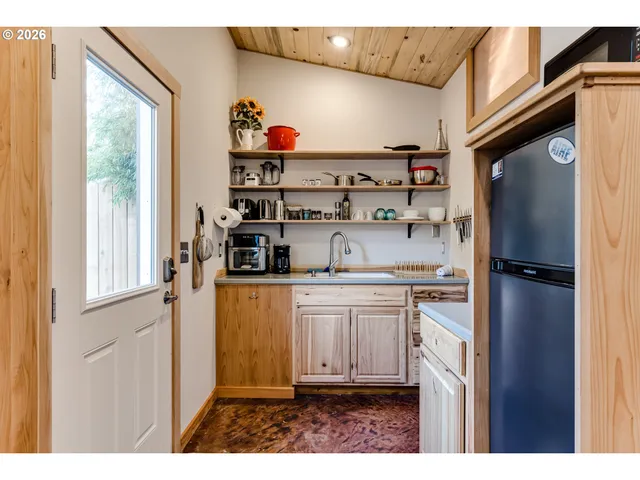 a kitchen with stainless steel appliances granite countertop a refrigerator and a stove