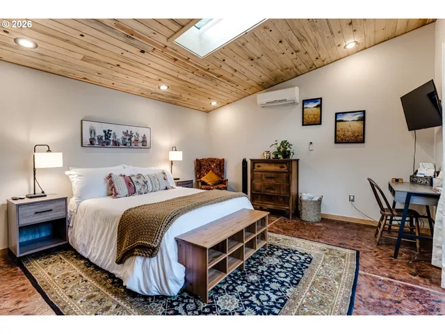 a bed room with a bed and a television