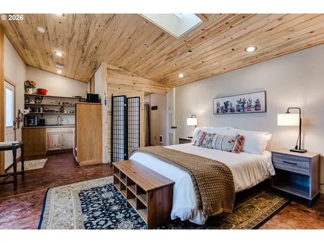 a bed room with a bed and a television