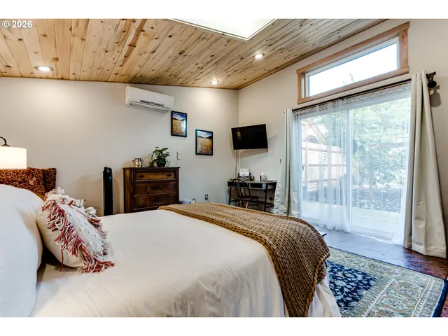 a bedroom with a bed and a large window