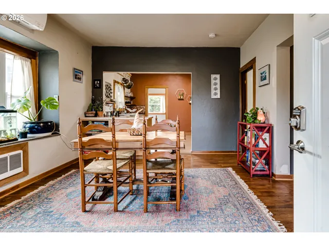 a dining room with furniture and wooden floor