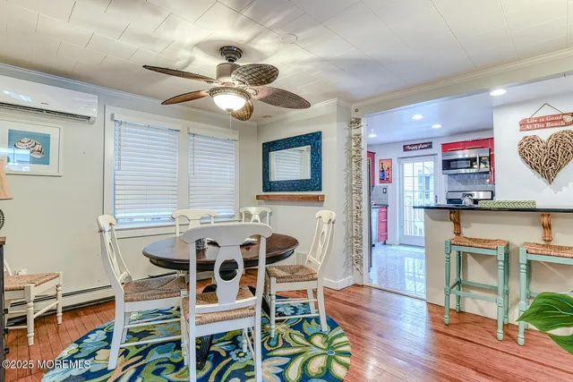 a view of a dining room with furniture a chandelier and wooden floor