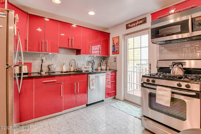 a kitchen with stainless steel appliances granite countertop a stove sink and cabinets
