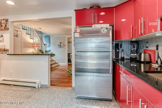 a kitchen with stainless steel appliances granite countertop a refrigerator and a stove