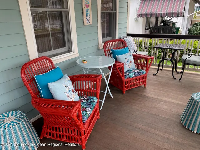 an outdoor sitting area with red umbrella