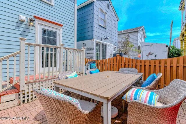 a view of a patio with a table and chairs