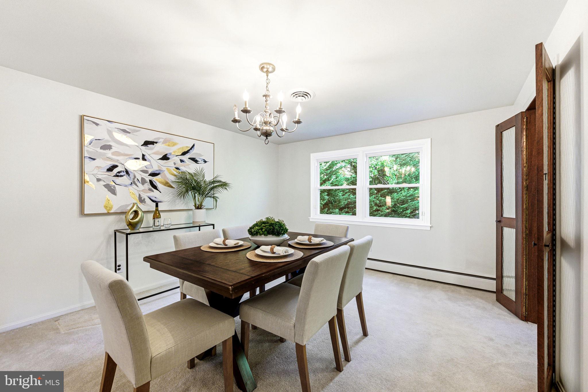 210 Cooper Drive Wallingford, PA 19086 - Photo 11 of 47 a view of a dining room with furniture and chandelier