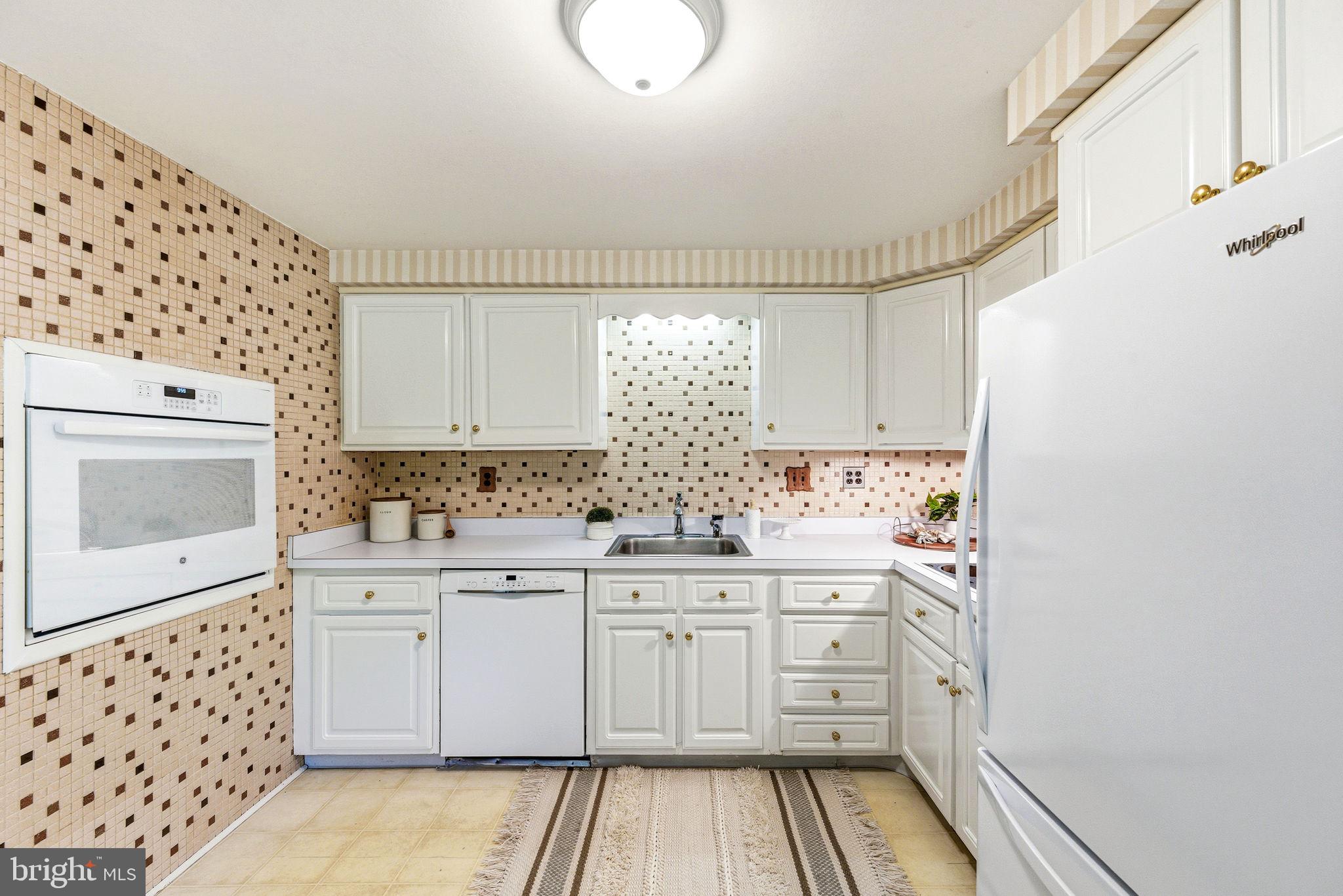 210 Cooper Drive Wallingford, PA 19086 - Photo 12 of 47 a kitchen with sink cabinets and window