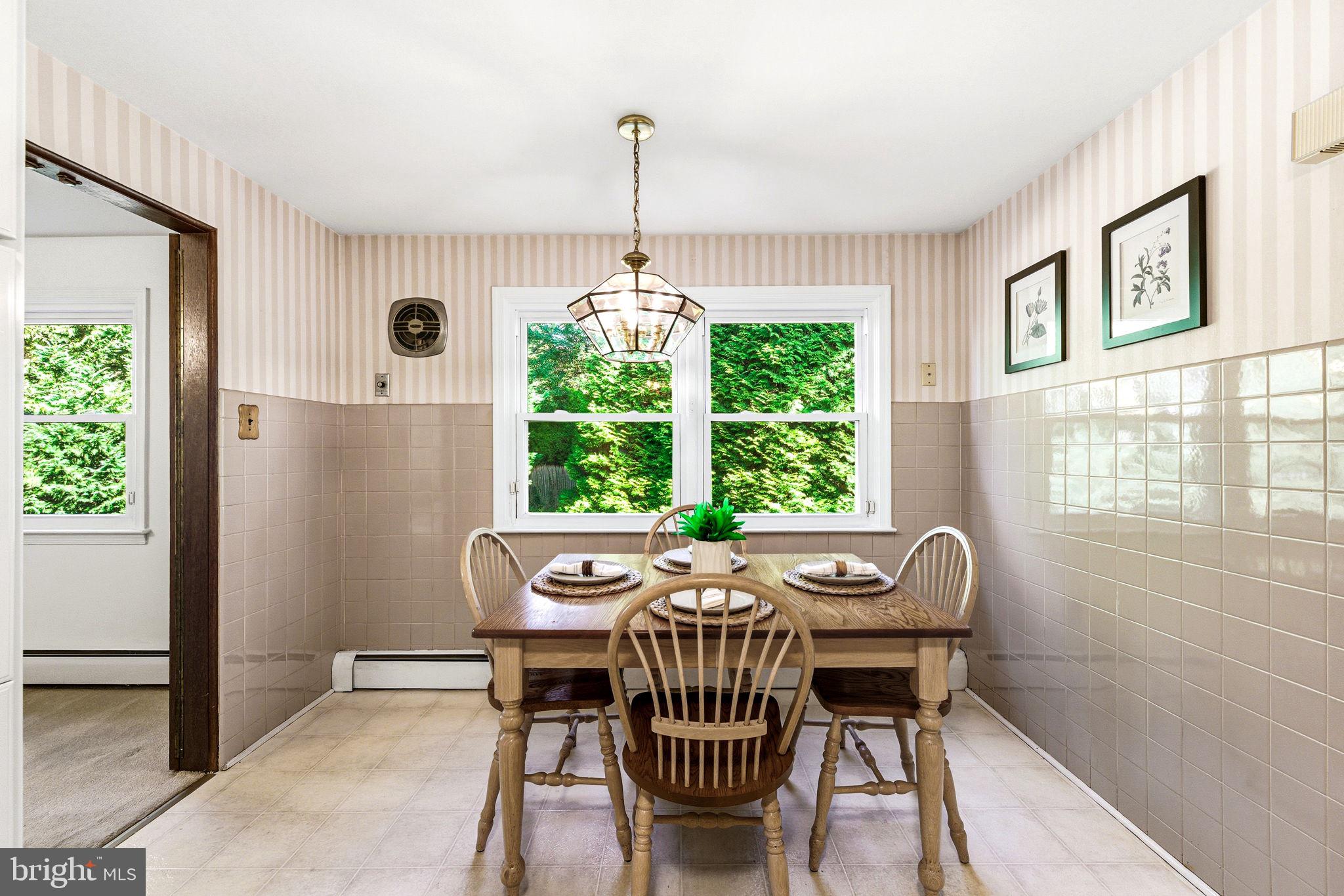 210 Cooper Drive Wallingford, PA 19086 - Photo 15 of 47 a view of a dining room with furniture window and outside view