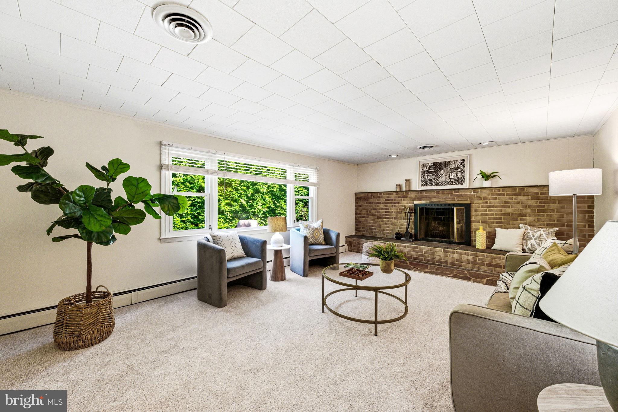210 Cooper Drive Wallingford, PA 19086 - Photo 16 of 47 a living room with furniture potted plant and a fireplace