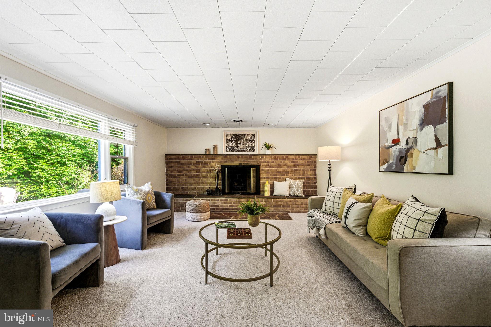 210 Cooper Drive Wallingford, PA 19086 - Photo 17 of 47 a living room with furniture and a fireplace