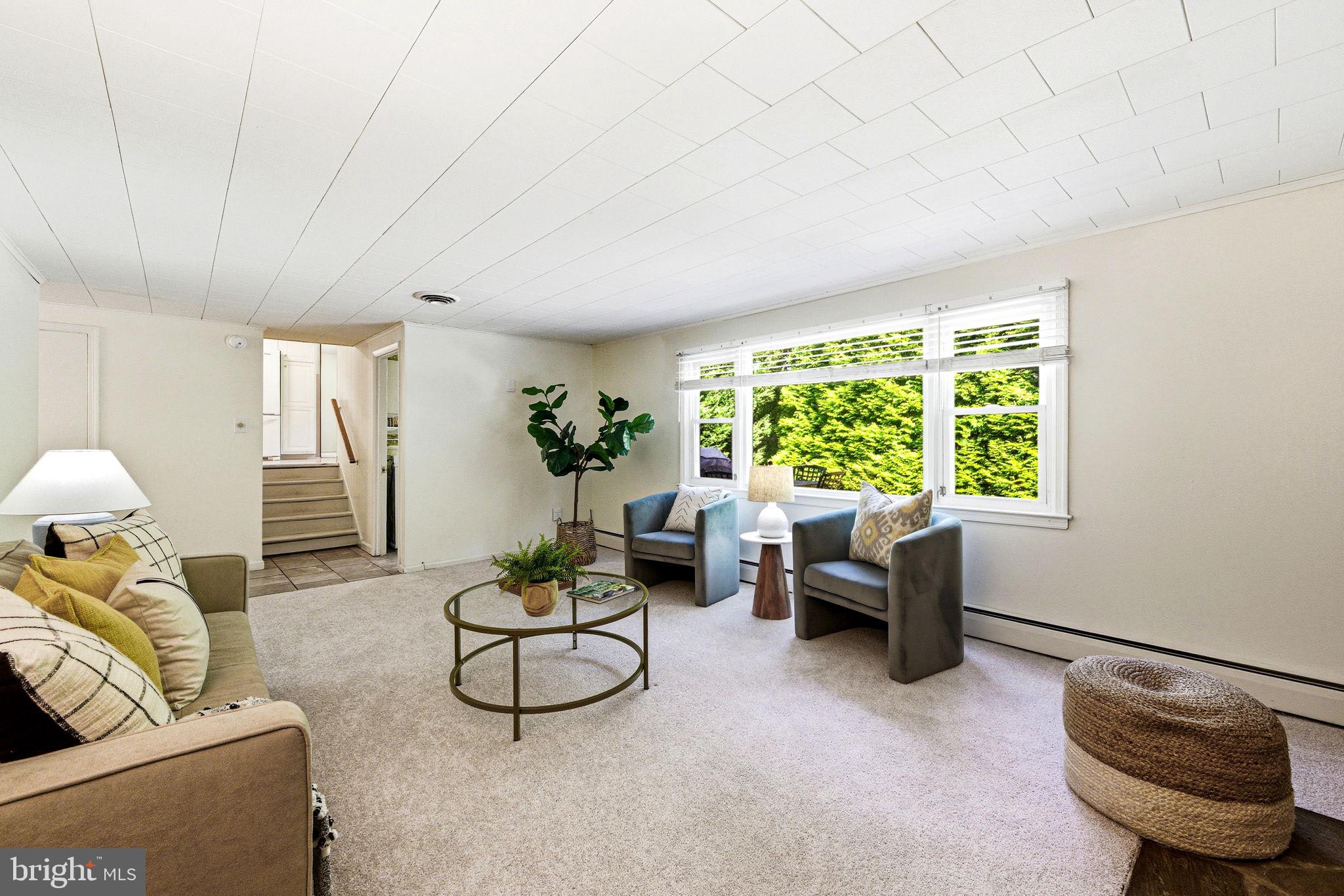 210 Cooper Drive Wallingford, PA 19086 - Photo 18 of 47 a living room with furniture and a large window