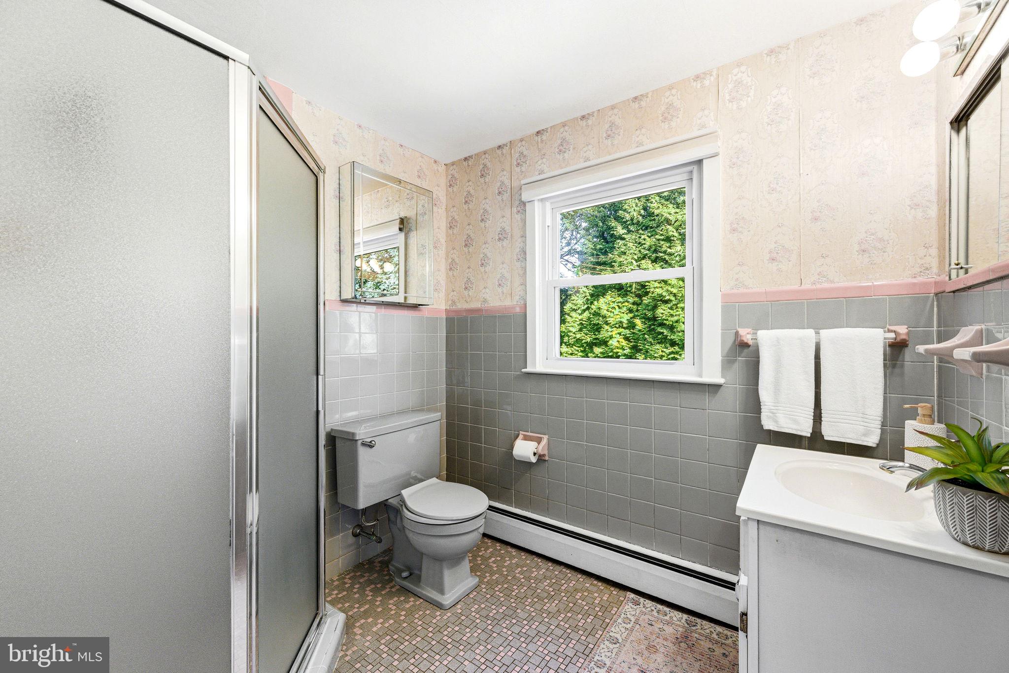 210 Cooper Drive Wallingford, PA 19086 - Photo 23 of 47 a bathroom with a toilet a sink and a window