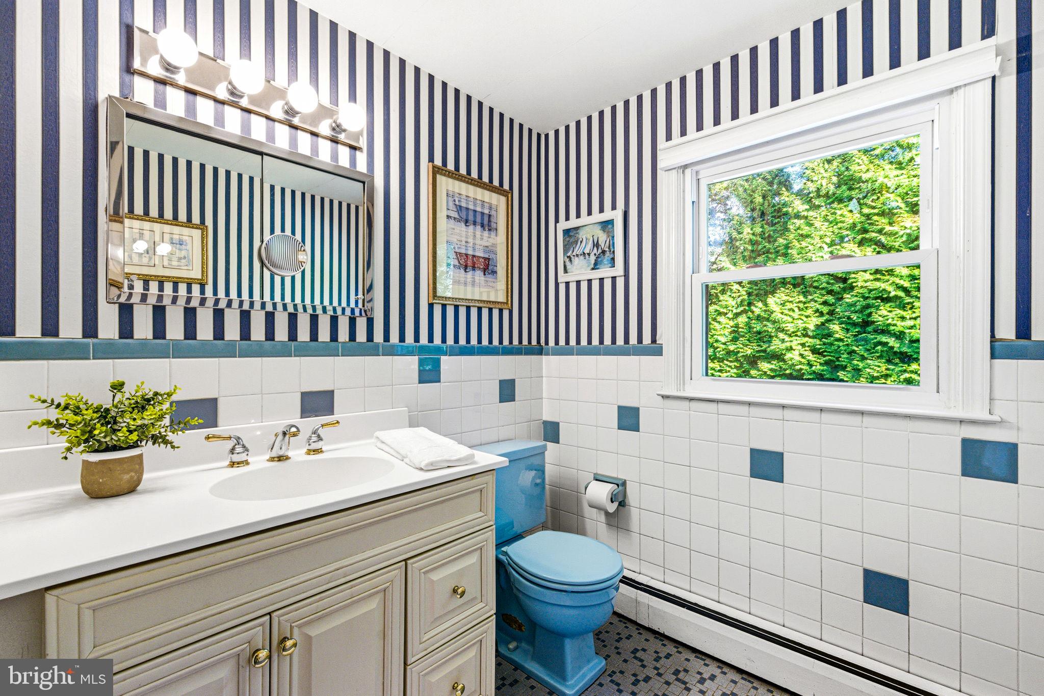 210 Cooper Drive Wallingford, PA 19086 - Photo 29 of 47 a bathroom with a sink a toilet and a window