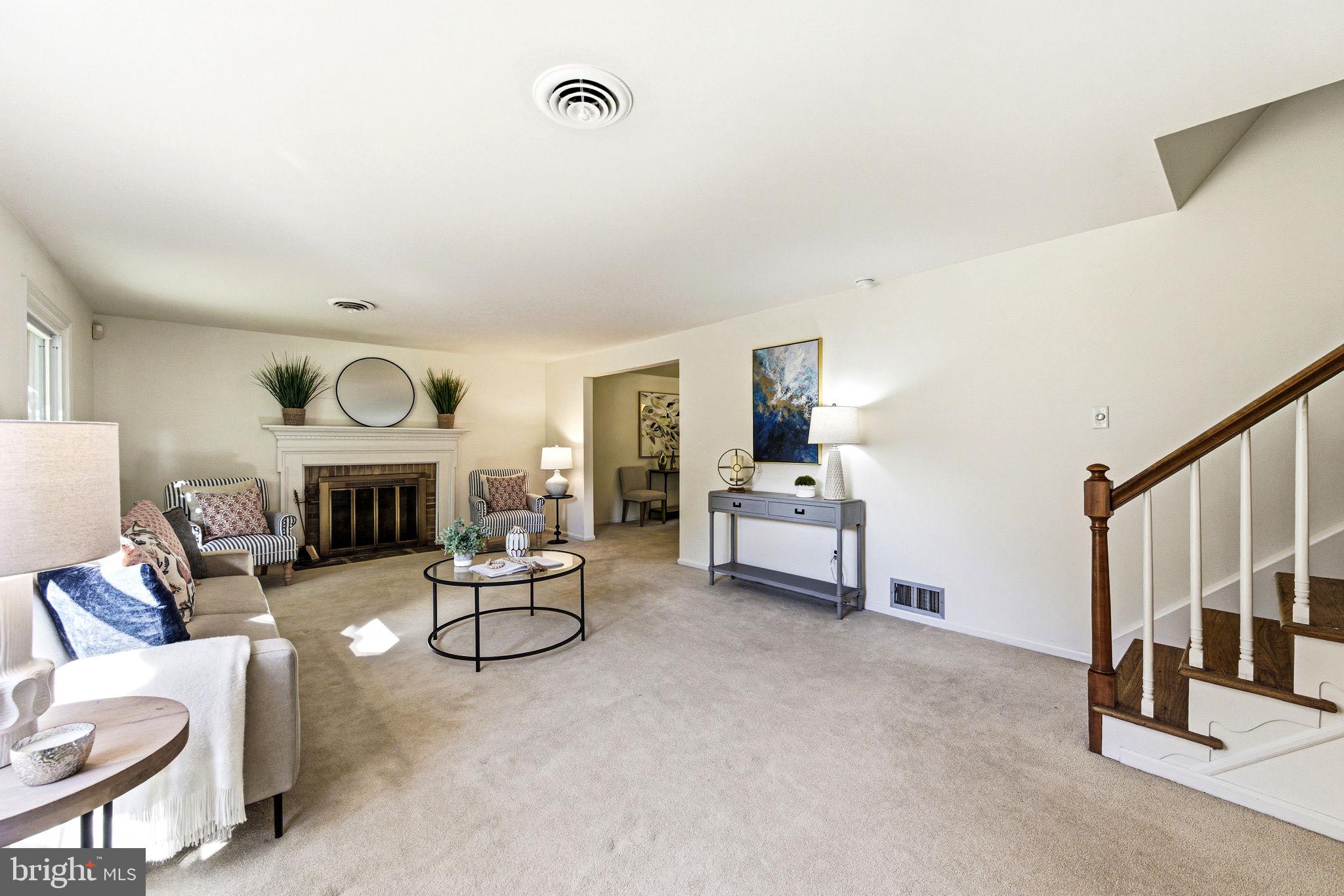 210 Cooper Drive Wallingford, PA 19086 - Photo 7 of 47 a living room with furniture and a fireplace