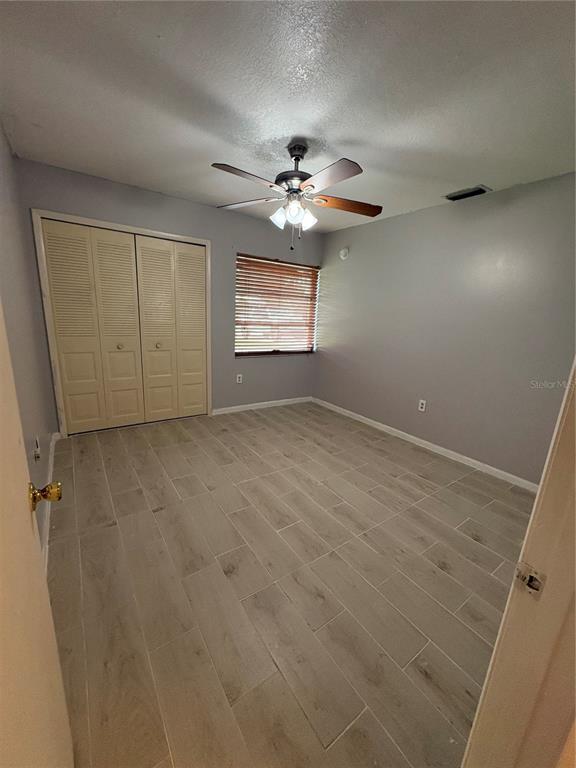 4027 Bianca Street Sebring, FL 33872 - Photo 7 of 22 an empty room with windows and fan