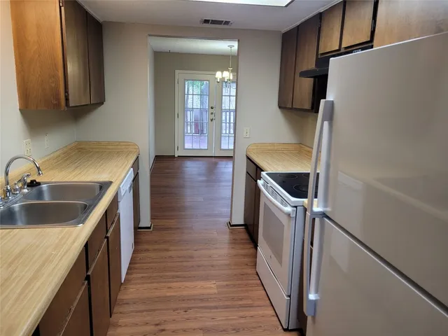 a kitchen with a sink and a refrigerator