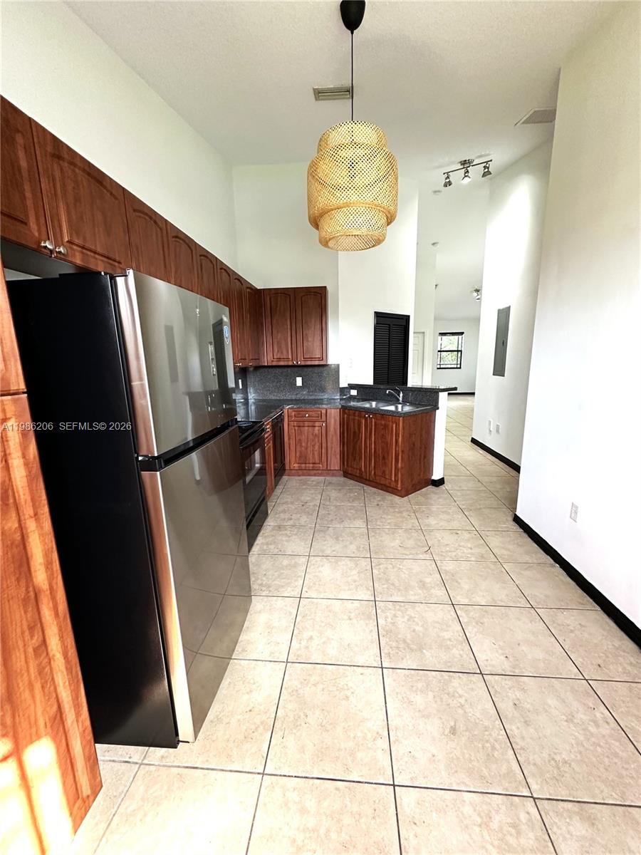 3550 Northeast 5th Street, Unit 202 Homestead, FL 33033 - Photo 14 of 23 a large kitchen with a counter space stainless steel appliances and cabinets
