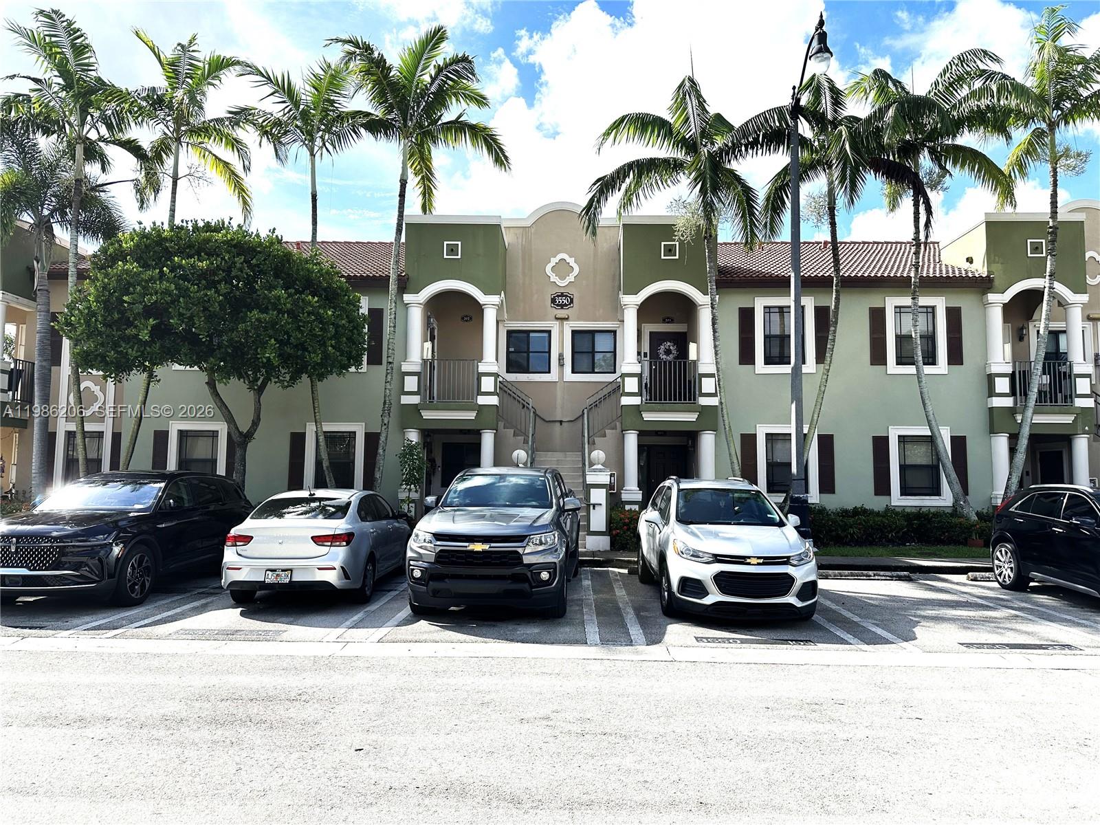 3550 Northeast 5th Street, Unit 202 Homestead, FL 33033 - Photo 2 of 23 a couple of cars parked in front of a house