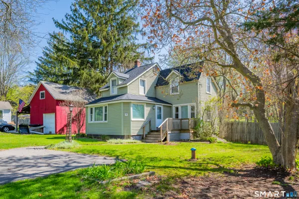 a front view of house with yard and green space