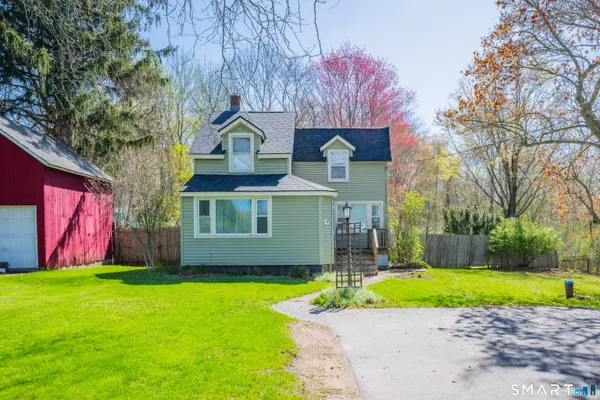 a front view of house with yard and green space