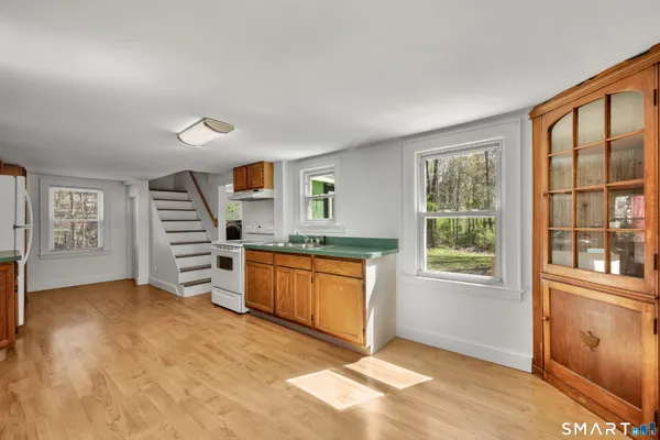 a view of a kitchen with a sink cabinet and a window