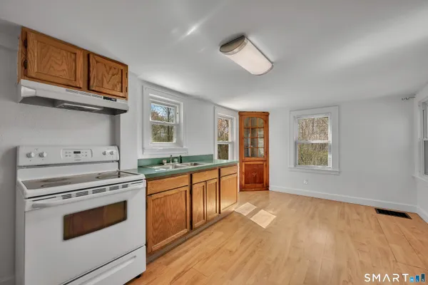 a kitchen with stainless steel appliances granite countertop a stove and a sink