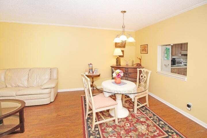 784 Nantucket Circle, Unit A Lake Worth, FL 33467 - Photo 12 of 30 a dining room with furniture and a chandelier