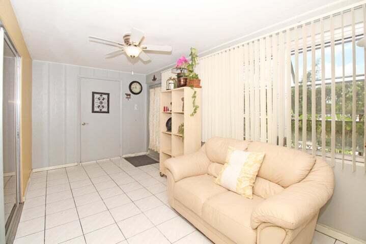 784 Nantucket Circle, Unit A Lake Worth, FL 33467 - Photo 13 of 30 a living room with furniture and a large window