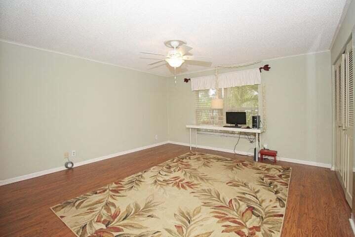 784 Nantucket Circle, Unit A Lake Worth, FL 33467 - Photo 15 of 30 a bedroom with a bed and a window