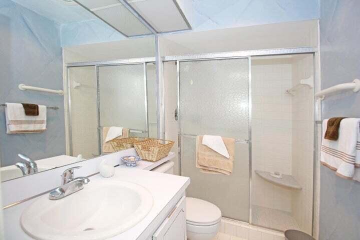 784 Nantucket Circle, Unit A Lake Worth, FL 33467 - Photo 17 of 30 a bathroom with a sink toilet and shower