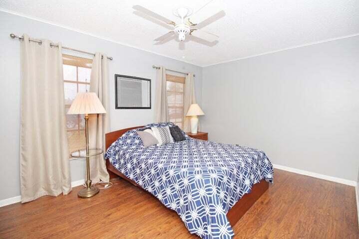 784 Nantucket Circle, Unit A Lake Worth, FL 33467 - Photo 20 of 30 a bedroom with a bed and a table with closet