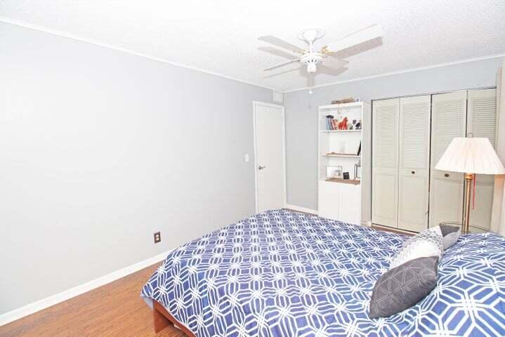 784 Nantucket Circle, Unit A Lake Worth, FL 33467 - Photo 21 of 30 a bedroom with a bed and a chandelier