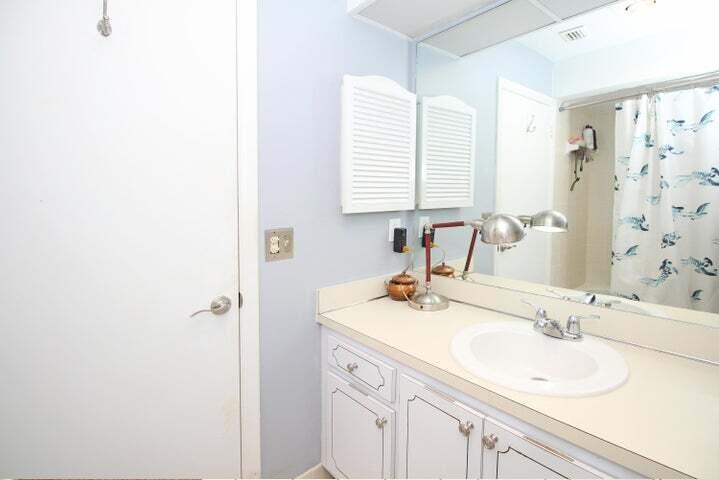 784 Nantucket Circle, Unit A Lake Worth, FL 33467 - Photo 22 of 30 a bathroom with a sink and a mirror