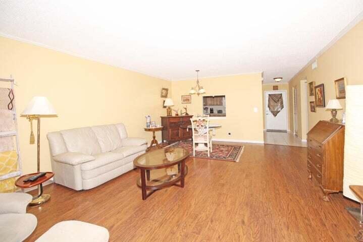 784 Nantucket Circle, Unit A Lake Worth, FL 33467 - Photo 7 of 30 a living room with furniture and a wooden floor
