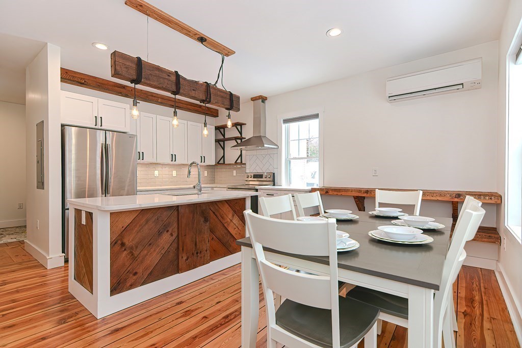166 Littleton Road, Unit 1 Harvard, MA 01451 - Photo 1 of 23 a kitchen with a dining table chairs and refrigerator